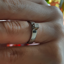 Load image into Gallery viewer, White gold ring with a diamond on a finger against a blurred background