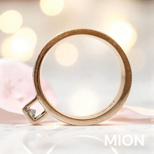 Load image into Gallery viewer, White gold ring with a diamond on a soft, blurred background with 'MION' branding.