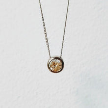Load image into Gallery viewer, A diamond solitaire pendant with a silver chain attached, set on a white background.
