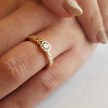 Load image into Gallery viewer, 0.5ct_Diamond_Solitaire_Engagement_Ring_in_textured Recycled_9ct_Gold worn on models hand