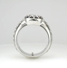 Load image into Gallery viewer, 18ct white gold ring, featuring a striking star-shaped setting surrounded by a halo of sapphire petals, with diamonds extending along the shoulders.